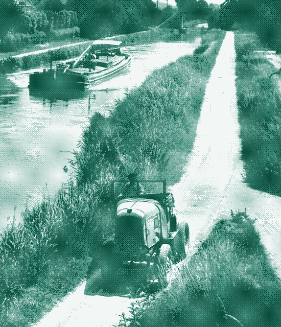 Image: A car pulls a barge.