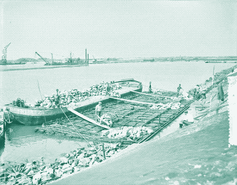 Image: Workers install fascine matttresses for the construction of locks in the Haringvliet near Hellevoetsluis, 1956. By Anefo, CC0.