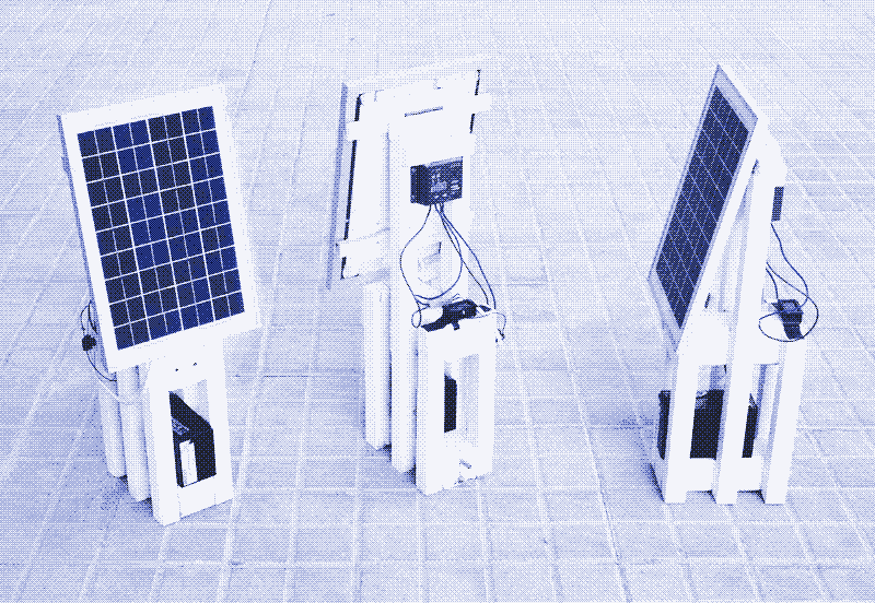 Image: a solar panel with charge controller and lead-acid battery. Photo by Marie Verdeil.
