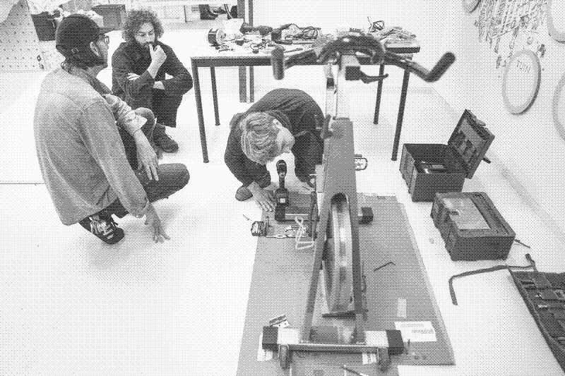 Tommy, Finn and Luke help with bike mechanics. Photo by Frans Hanswijk.
